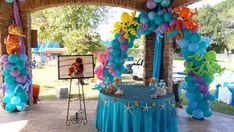 an outdoor party with balloons and decorations