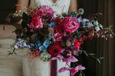 a woman holding a bouquet of flowers in her hands