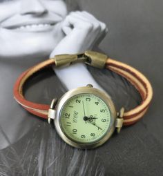 This is a unusual casual watch model for man or woman. The watch head is made in alloy, free of nickel and lead, aged bronze finish, round shape, 1.25 inches diameter. The wristband is made with two piece of genuine oil tanned leather, treated with a protective coating to make it tear resistant and fire resistant. This kind of leather is the same used on logger boots. The closure is made in alloy, also aged bronze finish, folding over type. Comes in 8 sizes:   XS    for a 6.00 inches wrist Wrist Watch Design, Unusual Watches, Watch Simple, Logger Boots, Classy Watch, Simple Watches, Green Watch, Watches Women Leather, Minimalist Watch