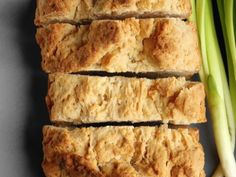 sliced scones next to celery on a gray surface with a knife and fork