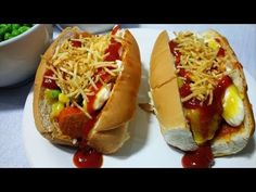 two hot dogs on buns covered in condiments