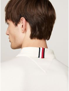 Tommy Hilfiger men's polo. This polo shirt is crafted from pure cotton with a smooth finish, lending a sleek look to the traditional design.  Material: 100% Better Cotton Initiative. Classic Polo T-shirt With Striped Collar, Classic White Collared Polo Sweater, Classic White Polo Sweater, White Classic Polo Sweater With Johnny Collar, Classic White Polo Sweater With Johnny Collar, Classic Cotton Polo Sweater With Striped Collar, White Cotton Polo Sweater With Polo Collar, White Cotton Polo Collar Sweater, Modern Polo Top With Striped Collar