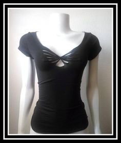 a female mannequin wearing a black shirt with a bow at the front and back