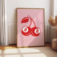 a pink poster with two cherries on it in front of a radiator