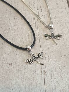 Lovely Dragonfly Charm Necklace Antique silver charm on either black waxed cord or silver plated curb chain The waxed cord is approx 18.5 inches long which includes the extension chain The silver plated chain is available in either 18 or 20 inch lengths Your necklace will be lovingly packaged inside an organza gift bag can be sent direct to the recipient if required, please leave a note at the time of checkout All items are posted free of charge via Royal Mail second class post the same or next working day I have many more necklaces and earrings for sale including a complete Dragonfly set which consists of matching earrings and necklace Please note overseas deliveries are taking longer than usual to arrive so please allow a delay in receiving your order. All orders outside of the UK are no Silver Casual Necklace With Adjustable Length, Casual Silver Necklace With Adjustable Length, Silver Necklaces With Adjustable Length And Waxed Cord, Silver Necklace With Adjustable Length And Waxed Cord, Silver Waxed Cord Necklace For Gift, Silver Necklace With Waxed Cord For Gift, Minimalist Silver Necklace With Waxed Cord, Adjustable Sterling Silver Necklace With Cord, Adjustable Black Sterling Silver Charm Necklaces