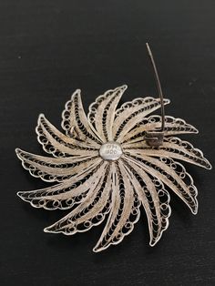 This stunning floral brooch has incredible detail on the silver work. This is all hand done and very time consuming! It has a double flower design and was handcrafted. This is made in 800 silver. Formal Flower Shaped Hallmarked Brooch, Flower Shaped Wedding Brooches Hallmarked, Wedding Flower Brooches Hallmarked, Wedding Flower Brooch Hallmarked, Flower Shaped Wedding Brooches, Handmade Flower-shaped Silver Jewelry, Silver Flower Jewelry With Handmade Flowers, Elegant Silver Brooch With Intricate Design, Silver Flower Shaped Brooch With Floral Decoration