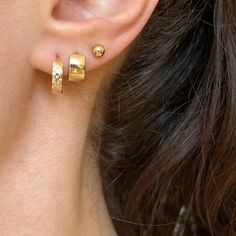 14KT yellow gold hinged, round huggie hoop earrings with scattered cubic zirconia stones. Shown in first ear hole of model. Length: 12.1mm Width: 12.6mm Thickness: 3.3mm Weight: 1.31 grams Stamped 14K Solid 14K gold Huggies/Hoop style as they "hug" the earlobe. Gold Hoop Piercings For Anniversary, 14k Gold Internally Threaded Huggie Earrings, Internally Threaded Hoop Huggie Earrings, Yellow Gold Round Huggie Earrings, Classic Gold Internally Threaded Huggie Earrings, Gold Plated Round Huggie Earrings With Lever Back, Gold Huggie Piercings For Anniversary, Gold Huggies, Saint Jewelry