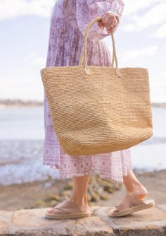 A timeless and chic tote that you can wear from spring to summer! Our Jane tote is a great accessory for running to the market and holding your goodies. Material: 100% Raffia Measurements: 13.5" x 22.8", Handle Drop- 8" Optional leather loop included to carry your fave hat Care: Spot Clean with Damp Cloth Natural Color Top Handle Shoulder Bag For Spring, Spring Crochet Bag With Handles In Natural Color, Vacation Beach Bag With Top Handle, Vacation Beach Bag With Top Handle And Rolled Handles, Spring Everyday Natural Shoulder Bag, Spring Natural Shoulder Bag For Everyday, Spring Natural Color Double Handle Bag, Spring Natural Shoulder Bag For Everyday Use, Natural Tote Bag For Daily Use