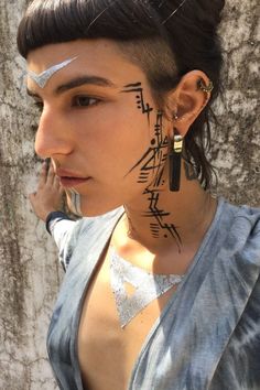 a woman with tattoos on her face and neck