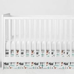 a white crib with animals on it