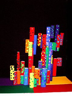 colorful blocks are stacked on top of each other in front of a black background with polka dots