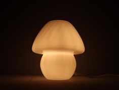 a mushroom shaped light sitting on top of a table