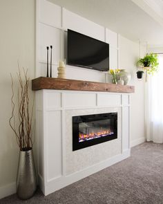 a living room with a fireplace and tv mounted on the wall, along with potted plants