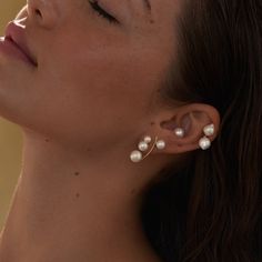 A decadent mix of our Pila Pearls and luscious round pearl ear jackets, this combination makes a bold and beautiful statement. Choose pink or white pearls, single or pair. Shown here with our Pearl Arc Earrings, Double Akoya Earrings, and Essential Pearl Stud (Large). ◆ Made to order, sold as singles. ◆ 14k solid yellow gold earring post & back◆ Freshwater Pearls (Studs): 4.5-5mm & 6-6.5mm ◆ Freshwater Pearls (Backs): 8-8.5mm ◆ Made in Los Angeles Elegant Single Ear Climber For Parties, Elegant White Ear Cuff For Formal Occasions, Elegant Ear Climbers For Party, Elegant White Ear Climbers For Formal Events, Elegant Pearl Ear Cuff Single Earring, Elegant Pearl Single Ear Cuff, Elegant White Ear Cuff With Pearl Drop, White Ear Climbers For Formal Occasion, Elegant White Pearl Drop Ear Cuff