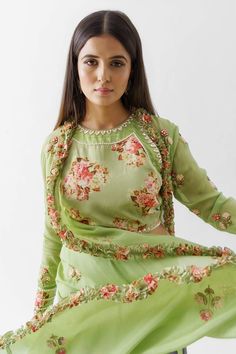 Green crop top featuring mirror embroidery and floral printed motifs, paired with flared, pleated pant. Comes with jacket with multi color embroidery and ruffle hem.

Component: 3
Pattern: Printed, Embroidered
Type Of Work: Print: Floral Motif; Embroidery: Mirror
Neckline: Top: Crew
Sleeve Type: Jacket: Straight Full
Fabric: Crepe, Georgette Crepe, Lining: Shantoon
Color: Green
Other Details: 
Padded top
Floral motif prints
Embroidered jacket
Ruffle hem jacket
Inverted pleated pant
Occasion: Meh Spring Saree Set With Mirror Work, Anarkali Sets With Mirror Work For Spring, Spring Anarkali Sets With Mirror Work, Spring Festive Choli With Intricate Embroidery, Long Sleeve Blouse With Mirror Work For Spring, Spring Georgette Set With Mirror Work, Spring Anarkali Choli With Intricate Embroidery, Spring Reception Sets With Intricate Embroidery, Georgette Palazzo Set With Floral Embroidery