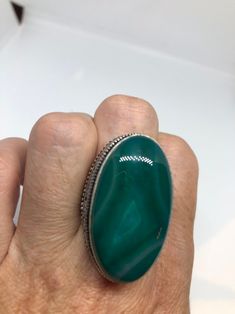 Large green agate Ornate German Silver Vintage ring, does not tarnish Size 9 can be re sized, my jeweler charges a $10 - $15 fee All rings are shipped in a nice gift box. Check out our over a THOUSAND great reviews Engraving is $4 per letter and is not always perfect depending on the piece. It can take a few days if the jeweler is busy. This is payable to Paypal Judithsltd@gmail.com Green Malachite Rings As A Gift, Green Agate Oval Rings, Green Oval Agate Rings, Adjustable Green Rings With Natural Stones, Green Onyx Rings For Gift, Green Oval Rings With Natural Stones, Oval Green Onyx Gemstone Ring, Oval Green Onyx Rings, Spiritual Green Ring With Large Stone