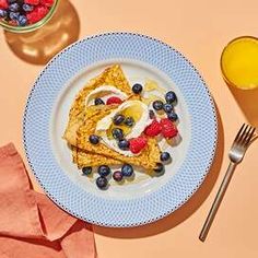 a plate with french toast and berries on it