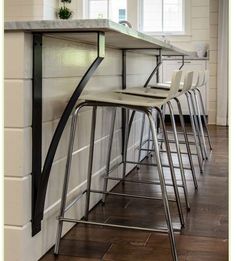 the bar stools are lined up against the wall