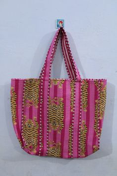 "Here's your all season Long tote bag. Beautifully Cotton fabric with Tiger pattern and padded Quilted Work very delicate and feminine look. Fabric is traditionally hand block printed in Tiger Prints  . We work with a small and family owned block print fabric makers and sewers to make these Long tote bags. Item :- Cotton Handbag Material: 100% Cotton Color - Pink Pattern: Quilted Bag Style: Tote Bag Size in Inch:- Length - 19\" inch Width - 25\" inch Handle - 11\" inch Product Work: Printed & quilted Stitched Usage : Perfect for Plastic Bag substitute. Can carry up to two wine bottles or about 3 bananas, 1 papaya, 4 avocados and 1 watermelon.  Make a good Sustainable Gift . Perfect for beach, city stroll or to go to the market! Easily foldable, light weigh - ideal to keep in your travel lu Pink Reversible Rectangular Shoulder Bag, Pink Rectangular Reversible Shoulder Bag, Pink Reversible Shoulder Bag For Daily Use, Pink Rectangular Beach Bag With Removable Pouch, Summer Reversible Rectangular Bag, Reversible Multicolor Bag For Vacation, Multicolor Reversible Vacation Bag, Multicolor Reversible Bag For Vacation, Everyday Reversible Pink Shoulder Bag