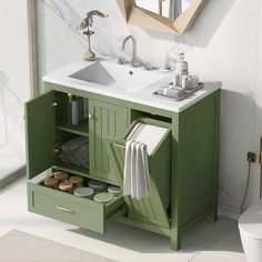 a bathroom vanity with two sinks and green cabinets