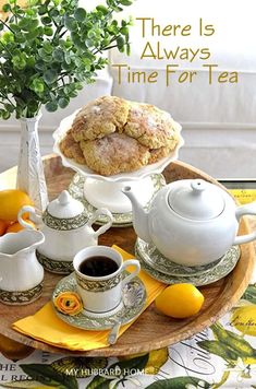 there is always time for tea with lemons and scones on the table next to it