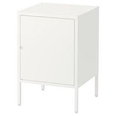 a white cabinet sitting on top of a wooden floor