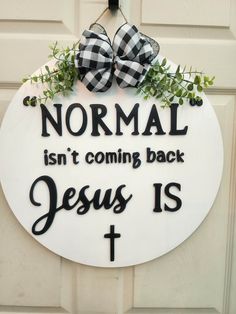 a white door with a sign that says normal isn't coming back jesus is