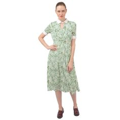 Embrace the elegance of 40s Dress Style with our Mint Green Floral Dress, a timeless and romantic piece that captures the essence of vintage fashion. This Green Floral Midi Dress is a perfect representation of Spring Summer style, featuring a delicate A-line silhouette and a beautiful light mint green daisy floral pattern print. Made from chiffon material, this Romantic Dress ensures a luxurious feel and graceful movement. The dress is fully lined, and its fine sewing craftsmanship is evident in every detail. The straight collar neckline with keyhole detailing and button enclosure adds a touch of sophistication, while the short sleeves contribute to the overall classic appeal. The mock elastic waistline creates a flattering silhouette, and the A-line midi skirt adds a sense of grace and ch Elegant A-line Midi Dress For Vintage Fashion, Retro A-line Midi Dress For Garden Party, Vintage A-line Midi Dress For Garden Party, Elegant Knee-length Vintage Dress With Floral Print, Elegant Knee-length Floral Vintage Dress, Retro Midi Dress For Garden Party, Classic Vintage Midi-length Dress For Spring, Elegant Vintage Fashion Dresses With Floral Print, Classic Vintage Midi Dress For Spring