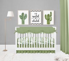 a baby crib with green and white bedding in front of a gray wall