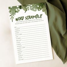 a green and white printable word scramble on a sheet of paper next to a blanket