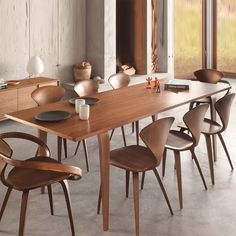 a dining room table with chairs around it and a fireplace in the backround