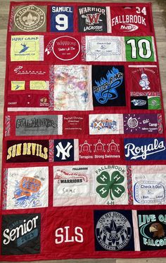 a quilt made to look like it has many different logos on it and is laying on the floor