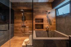 a modern bathroom with wooden walls and flooring