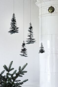 three small christmas trees hanging from the ceiling