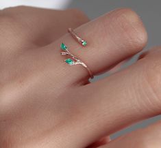 Shop our beautiful Original 925 Silver two green Ivy Olive Shaped Leaf Ring on Etsy. This dainty and elegant ring is handmade with love and care, featuring a unique olive tree design. Wear it as a symbol of protection against the evil eye, or simply as a stylish accessory for everyday wear. This stackable ring makes a perfect gift for birthdays, Christmas, or for your best friend. Invest in your beauty and add this handmade leaf design tree branch ring to your jewelry collection today! Find the perfect gift for your loved one with our minimalist heart shape infinity necklace. This elegant piece of jewelry is a symbol of eternal love and makes a great Valentine's Day or anniversary present. Add a touch of romance to your outfit with this beautiful necklace, handmade with care and attention Fine Jewelry Flower Ring For May Birthstone, Delicate Green Sterling Silver Jewelry, Emerald Flower Ring Gift In Green, Nature-inspired Ring With May Birthstone For Gift, Green Open Ring For Promise, Green Open Flower Ring For Promise, Elegant Green Sterling Silver Flower Ring, Elegant Green Flower Ring In Sterling Silver, Dainty Green Birthstone Open Ring