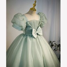 This elegant Princess Square Floor Length Tulle dress in Sage Green is perfect for any special occasion, including Baptisms, Birthdays, and Weddings. The beautifully adorned bow and puff sleeves add a delicate touch, while the crossed straps and square neckline provide a sophisticated silhouette. Made with high-quality tulle fabric, this dress ensures comfort and style for your little flower girl. Bridal Hair Accessories Flower, Long Flower Girl Dresses, Tulle Flower Girl Dress, Empire Wedding Dress, Tulle Flower Girl, White Flower Girl Dresses, Tulle Flowers, Backless Wedding, Flower Girl Dresses Tulle