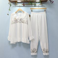 The Flowered Cotton Spring Pajamas includes a long sleeve top and trousers and is the perfect set to buy when you want to feel relaxed and in peace in the comfort of your house! We are passionate about fabric and textile materials and have thus created the best, most comfortable yet practical line of pajamas. This loungewear is all you need to help relax at home. They are soft and easy to touch which projects versatility and effortless grace in every step you take. Made to make you feel good, ea Spring Pajamas, Lounging Outfit, Women's Fashion Set, Comfortable Pajamas, In Peace, Fashion Essentials, Types Of Collars, Stretchy Material, Sleeve Cotton