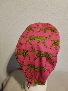 "Scrub hat. Chemo hat. Chef Hat. Surgical Hat. Replacement for Motorcycle helmet Bandana. Made of a cotton fabric. Hot pink background with a mustard spotted jaguar. Lovely print. Triple stitched at the crown and tie strips. Inside has zero visible seams.Surgical Hat. Replacement for Motorcycle helmet Bandana. OSFM ( One size fits most) 21\" to 24\" head circumference. A tad bit more if not tied tightly. Washing instructions- This hat is 100% cotton. Wash in cold and line dry. Iron afterwards or Adjustable Pink Flat Cap, Pink Adjustable Flat Cap, Pink Jaguar, Pink Adjustable 5-panel Trucker Hat, Christmas Scrubs, Hot Pink Background, Handmade Scrub, Pink And Cream Scrub Caps, Navy Baby