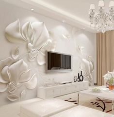 the living room is decorated in white and has flowers on the wall, chandelier,