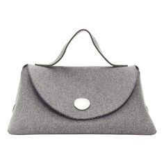 rare CELINE Phoebe Philo 2014 Runway Orb grey wool felt top handle bag Reference: TGAS/D00982 Brand: Celine Designer: Phoebe Philo Model: Orb Collection: 2014 - Runway Material: Wool Color: Grey, Silver Pattern: Solid Closure: Snap Buttons Lining: Blue Fabric Extra Details: The Orb Bag first appeared on the runway and is part of Celine's Winter 2014 Collection. The Orb Bag features a flap front with a rounded metal button. The Orb is designed to be worn as a large clutch with the handle resting on your arm and the base of the bag resting on your hip. Made in: Italy CONDITION: Condition: Very good, this item was pre-owned and is in very good condition. Please refer to image gallery for thorough condition check. Minor scratches on metal buttons. MEASUREMENTS: Width (width across base): 38cm Celine Phoebe Philo, Bag Reference, Bags 2014, 2014 Runway, Large Clutch, Phoebe Philo, Celine Bag, Handle Bag, Metal Buttons