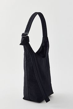 BAGGU small nylon sling bag in a bucket bag silhouette crafted from lightweight nylon. This BAGGU bag is finished with an interior zip pocket and adjustable shoulder bag strap. Features BAGGU small nylon sling bag BAGGU bag in bucket bag silhouette Interior zipper pocket Adjustable strap Content + Care 100% Nylon (59% recycled) Machine wash Imported Size Strap: 39" adjustable Dimensions: 7" w x 4.25" d x 9.5" h | BAGGU Small Nylon Sling Bag in Black, Women's at Urban Outfitters Baggu Bag, Bag Silhouette, Baggu Bags, Silhouette Crafts, Reusable Bags, Nylon Bag, Fit Inspo, Black Fits, Bag Straps