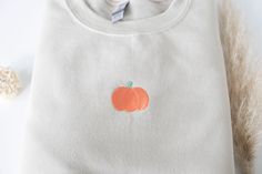 "Embroidered Pumpkin Sweatshirt Stay cozy in the pumpkin patch with this cute minimalist soft and warm embroidered fall sweatshirt! Made with love and THOUSANDS of threads! -Unisex Size (Please see the size chart for more details that can be found in the photos section) We recommend comparing your favorite sweatshirt to our size chart to find the best size for you! Unisex Crewneck Sweatshirt: -50% cotton 50% polyester -Super soft -Pre-shrunk -Unisex -Pumpkin size is 1.5\"\" (tiny but mighty!) Th Cute Custom Embroidered Tops For Fall, Cute Tops With Custom Embroidery For Fall, Embroidered Pumpkin, Thanksgiving Sweatshirt, Pumpkin Sweatshirt, Halloween Crewneck, Sweatshirt Trendy, Pumpkin Sweatshirts, Sweatshirt Halloween