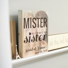 a couple of books sitting on top of a white shelf next to each other in front of a mirror