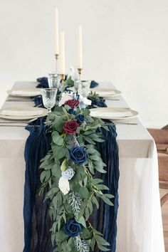 the table is set with blue and red flowers