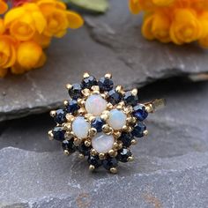 A stunning 9ct gold ring set with natural opals and sapphires in a cluster . Full hallmarks for Birmingham 1978 In excellent condition Finger size K 1/2 or 5 1/2 US Will arrive gift boxed Free tracked shipping/UK next day delivery 14k Gold Birthstone Cluster Ring, 14k Gold Cluster Ring With Birthstone, Gold Cluster Ring With Birthstone, Gold Birthstone Cluster Ring, Yellow Gold Birthstone Cluster Ring, Cluster Multi-stone Opal Ring For Anniversary, 14k Gold Cluster Ring Hallmarked, Gift Sapphire Cluster Ring, Sapphire Cluster Ring