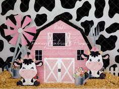 a pink barn with black and white cow decorations