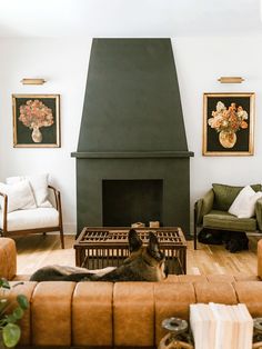 a dog laying on the floor in front of a fire place with two chairs and a couch