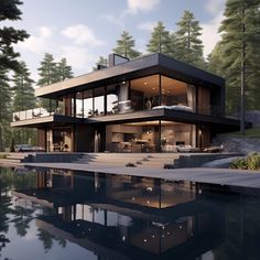 a large house sitting on top of a lush green hillside next to a lake and forest