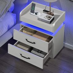 a night stand with two drawers and a phone on it