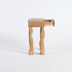 a small wooden table with two legs and a drawer on the top that is made out of wood